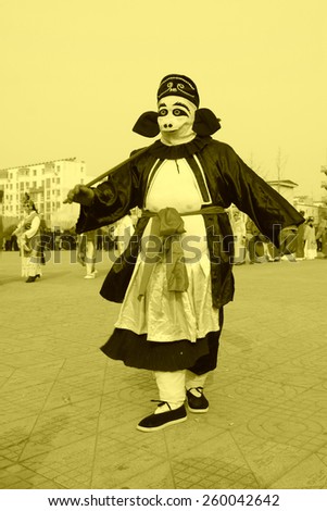 LUANNAN COUNTY - FEBRUARY 13: Zhu bajie\'s image wearing colorful clothes, performing yangko dance in the street, February 13, 2014, Luannan County, Hebei Province, China.