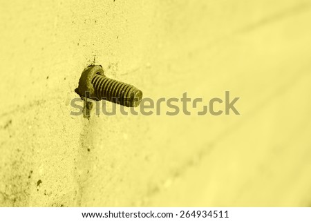 tighten bolts rust on concrete walls, closeup of photo