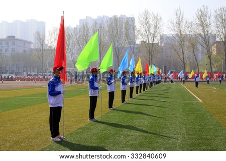 LUANNAN COUNTY - APRIL 14: Flag team in primary and secondary schools athletics meeting, April 14, 2015, Luannan County, Hebei Province, China
