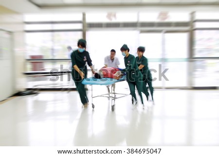 Health care workers rushed past emergency treatment hall, closeup of photo