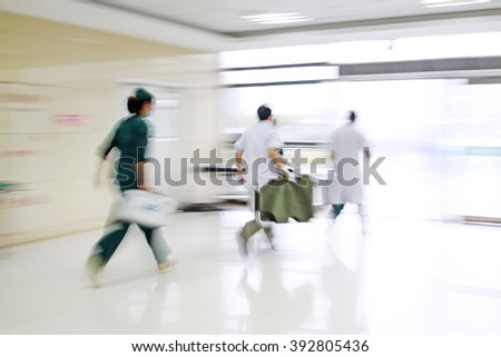 Health care workers rushed past emergency treatment hall, closeup of photo