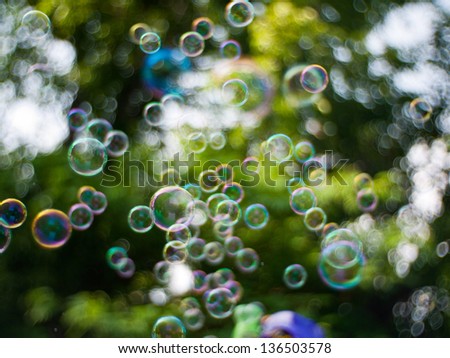 Rainbow bubbles in front of swirling abstract background