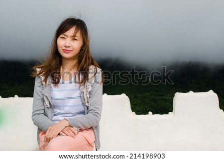 Woman sitting on mountain ,thailand