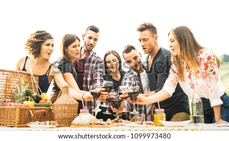 Young friends having fun outdoors drinking red wine at barbecue - Happy people eating healthy food at harvest time in farmhouse vineyard winery - Youth friendship concept on warm vintage filter