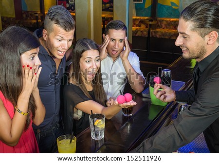 Barman performing magic Trick to surprised Guests