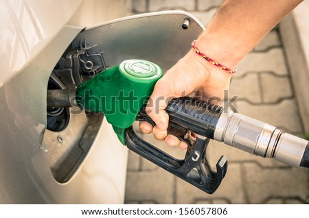 Male Hand refilling Gas at Fuel Station - Real Life Situation