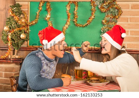 Young Couple flirting with american food at Christmas Dinner