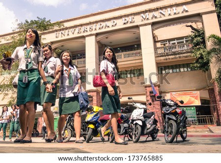 MANILA, PHILIPPINES - 29 JANUARY, 2014: young female students going out from \