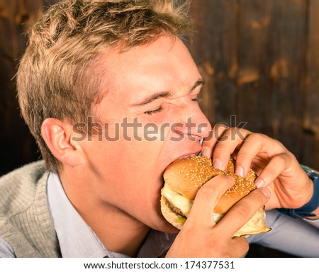 Handsome Man eating a Cheeseburger