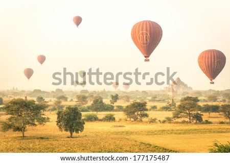 Bagan, Myanmar - February 13, 2014: Air Balloons Flying Over The Spectacular Plain Of Bagan Temples. Even If The Price Per Person Is Over 300 Dollars, Rides On The Balloons Are Mostly Full Booked.