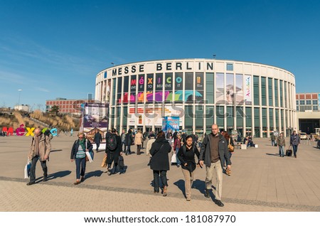 BERLIN, GERMANY - MARCH 8, 2014: attendees walking in and out from the south entrance at ITB Travel Trade Show in the fairgrounds of Messe Berlin.
