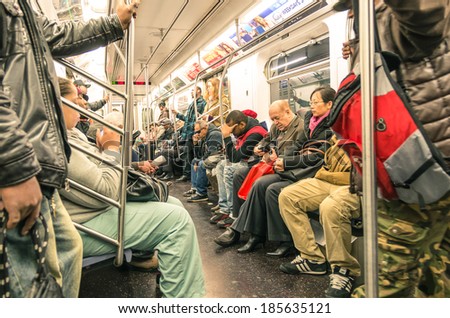 NEW YORK - NOVEMBER 2, 2013: mixed people in the subway, downtown Manhattan. The trains are the places where the most mixed melting pot in the world take place, and the real mirror of actual society.