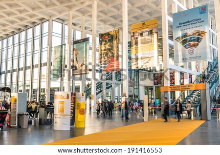 BERLIN, GERMANY - MARCH 8, 2014: attendees walking in and out from the south entrance at ITB Travel Trade Show in the fairgrounds of Messe Berlin.