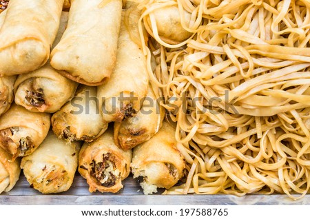 Deep fried spring rolls with noodles at street food market - Concept of unhealthy alimentation - Close up of asiatic food in Khao San Road