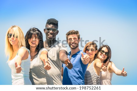 Group of multiracial happy friends with thumbs up - Concept of international friendship and success against racism and multiethnic social barriers