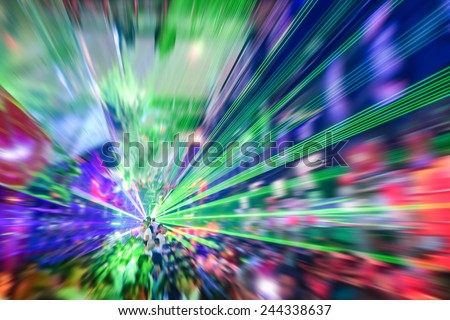 Laser show in modern disco party night club - Concept of nightlife with music and entertainment -  Image edited with radial zoom defocusing