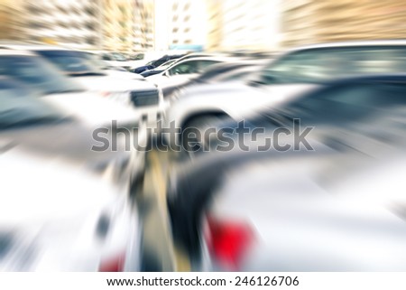 Modern generic unrecognizable cars at parking lot of company retail store - Concept of transportation and rental service with full optional insurance - Radial zoom defocusing