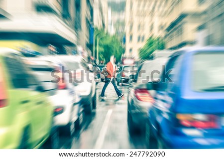 Person crossing the road during rush hour in Cape Town - Concept of connection between people and traffic jam on a vintage filtered look - Radial zoom defocusing of commuter cars on urban city streets