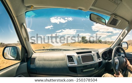 Travel journey from a car cockpit - Concept of adventure trip on the road to namibian exclusive destinations - Fisheye view on desert freeway in Namibia - Soft focus on landscape and clouds