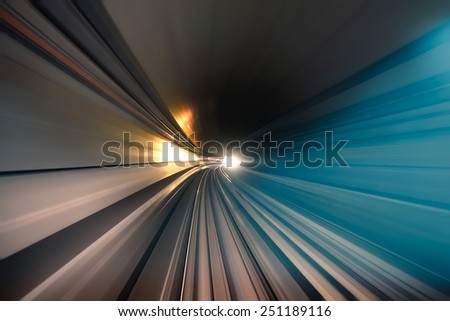 Subway tunnel with blurred light tracks in the gallery - Concept of modern metro underground transport and connection - Radial zoom motion blur due to the speed of the train