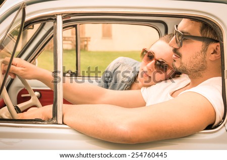 Couple in love having a rest during honeymoon vintage car trip - Hipster lifestyle traveling around the world with classic car - Young people enjoying happy moments of life - Warm retro filtered look