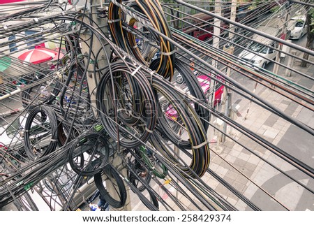 Messy electrical cables in Bangkok - Example of uncovered optical fiber technology open air outdoors in south east asian cities