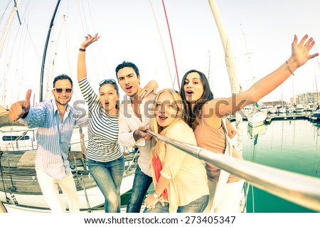 Best friends using selfie stick taking pic on exclusive luxury sailing boat - Concept of friendship and travel with young people and new technology  trends - Bright nostalgic desaturated color tones