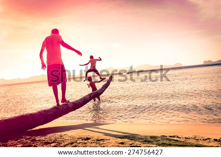 Father playing with sons at tropical beach with tilted horizon - Concept of  family union with man and children having fun together - Modified unrecognizable silhouettes - Marsala filtered color tones