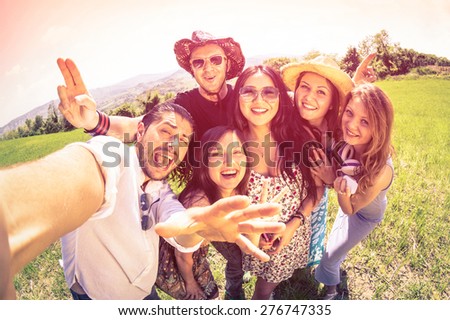 Best friends taking selfie at countryside picnic - Happy friendship concept and fun with young people and new technology trends - Vintage filter look with marsala color tones - Fisheye lens distortion