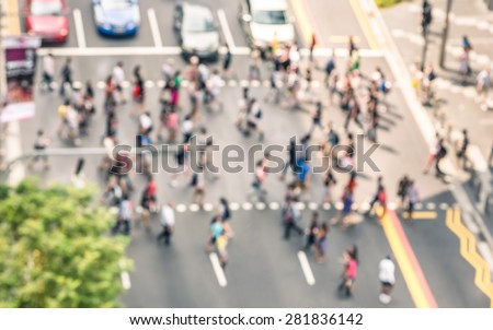 Blurred defocused abstract background of people walking on the street in Orchard Road in Singapore - Crowded city center during rush hour in urban business area zebra crossing - View from building top