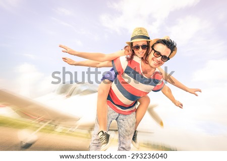 Happy hipster couple in love on airplane travel honeymoon vacation - Young models summer concept at luxury trip excursion - Best friends having fun - Soft vintage filter with radial zoom defocusing