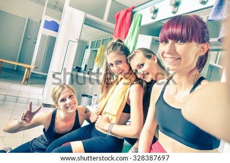Happy girlfriends group taking selfie in gym dressing room - Sporty female friends ready for fitness time - Healthy lifestyle and sport concept in training center - Bright vintage desaturated filter