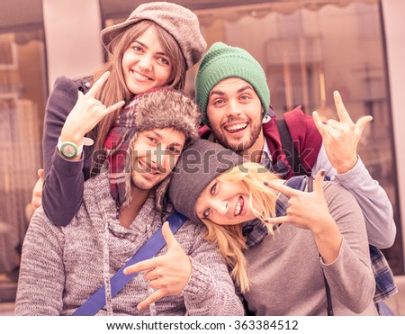 Best friends taking selfie outdoors with funny face expression and fashion clothes - Happy friendship concept with young hipster people having fun together - Vintage marsala filtered color tones