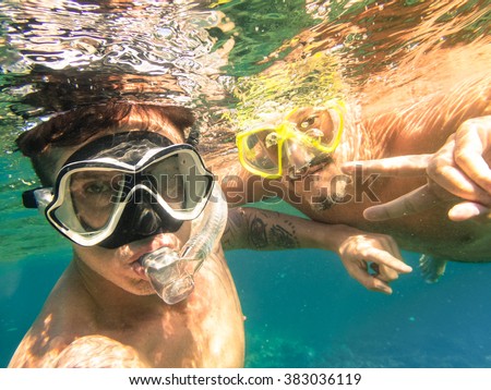 Adventurous best friends taking selfie snorkeling underwater - Adventure travel lifestyle enjoying happy fun moment - Trip together around Philippines wonders - Soft focus due to water density