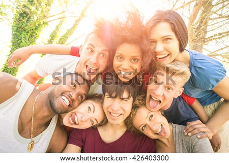 Best friends taking selfie outdoor with back lighting - Happy youth concept with young people having fun together - Cheer and friendship against racism - Vintage marsala filter and sunshine halo flare