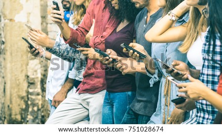 Group of multicultural friends using smartphone outdoors - People hands addicted by mobile smart phone - Technology concept with connected men and women - Shallow depth of field on vintage filter tone