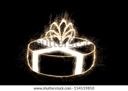 Packed round gift by sparkler style with freeze light on black background