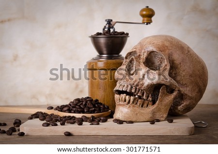 coffee bean on scoop,grinder and human skull