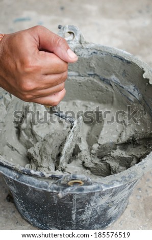 Applying construction trowel in wet cement