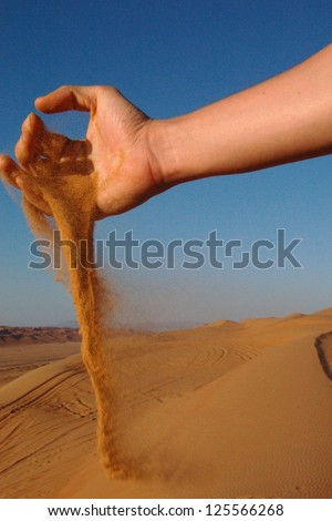 Sand Grains Falling Through Hand