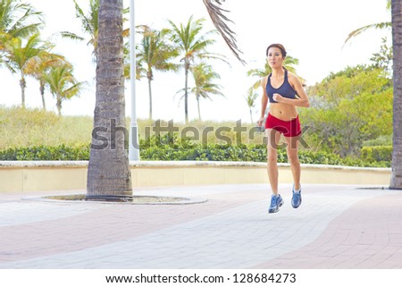 Sporty Asian woman jogging early morning. Horizontal Shot. Miami Beach, Florida.