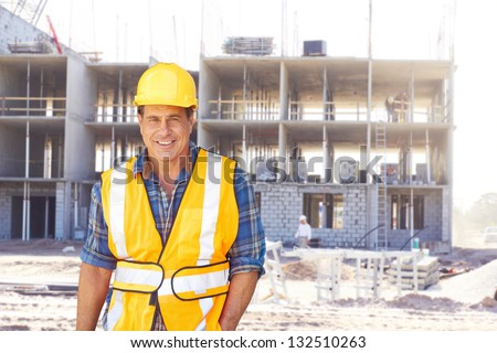 Portrait of a happy building contractor at construction site. Horizontal shot.