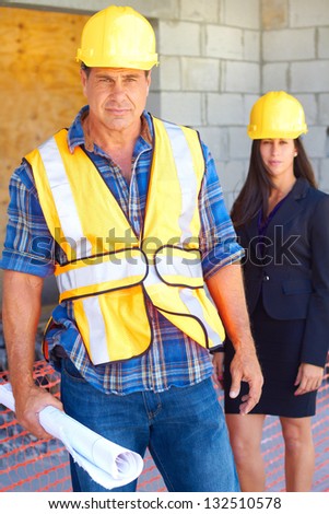 Architect and foreman together at construction site.