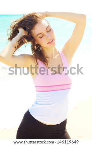 Close up of beautiful female relaxed at the beach with clear skin