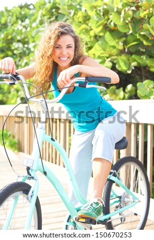 Happy Female Taking A Break On Boardwalk With Bicycle Smiling
