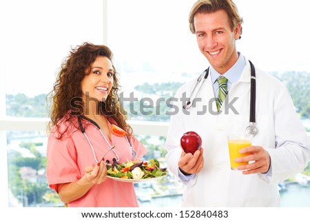 nurse and doctor holding health food as a prescription for good health.