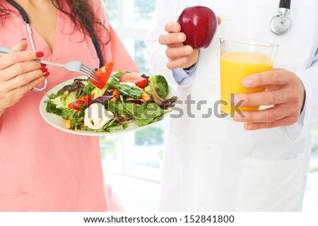 nurse and doctor holding health food as a prescription for good health.