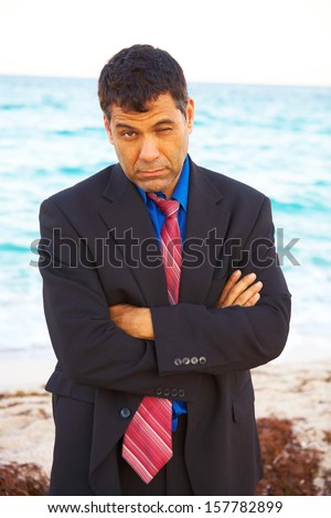 business man at beach after losing his job depressed and worried.