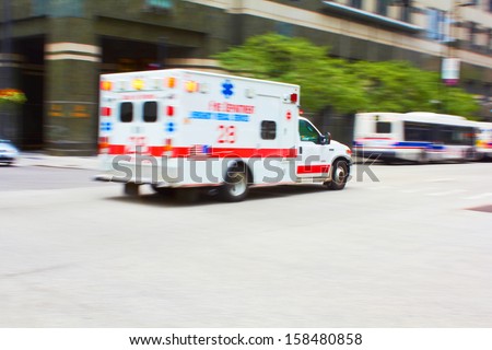 Speeding Ambulance to the Rescue in the City, motion blurred to add speed effect.
