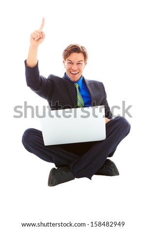 Happy business male on laptop looking at the lap top computer screen excited holding up we are number one finger.